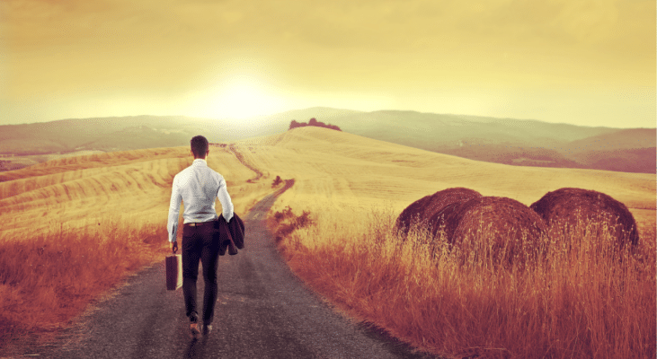 man walking alone on a long arduous path