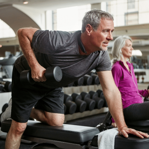 older man performing dumbell lat rows